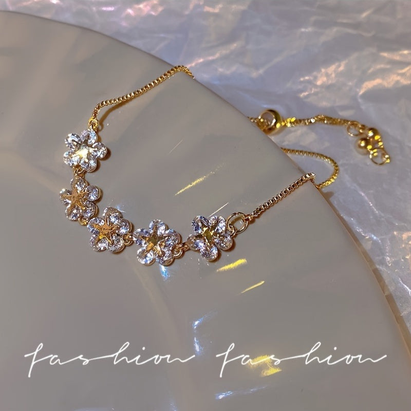 Elegant flower bracelet with rhinestones, zinc alloy fashion jewelry for women. Adjustable chain, suitable for daily and party wear. Great gift for friends.