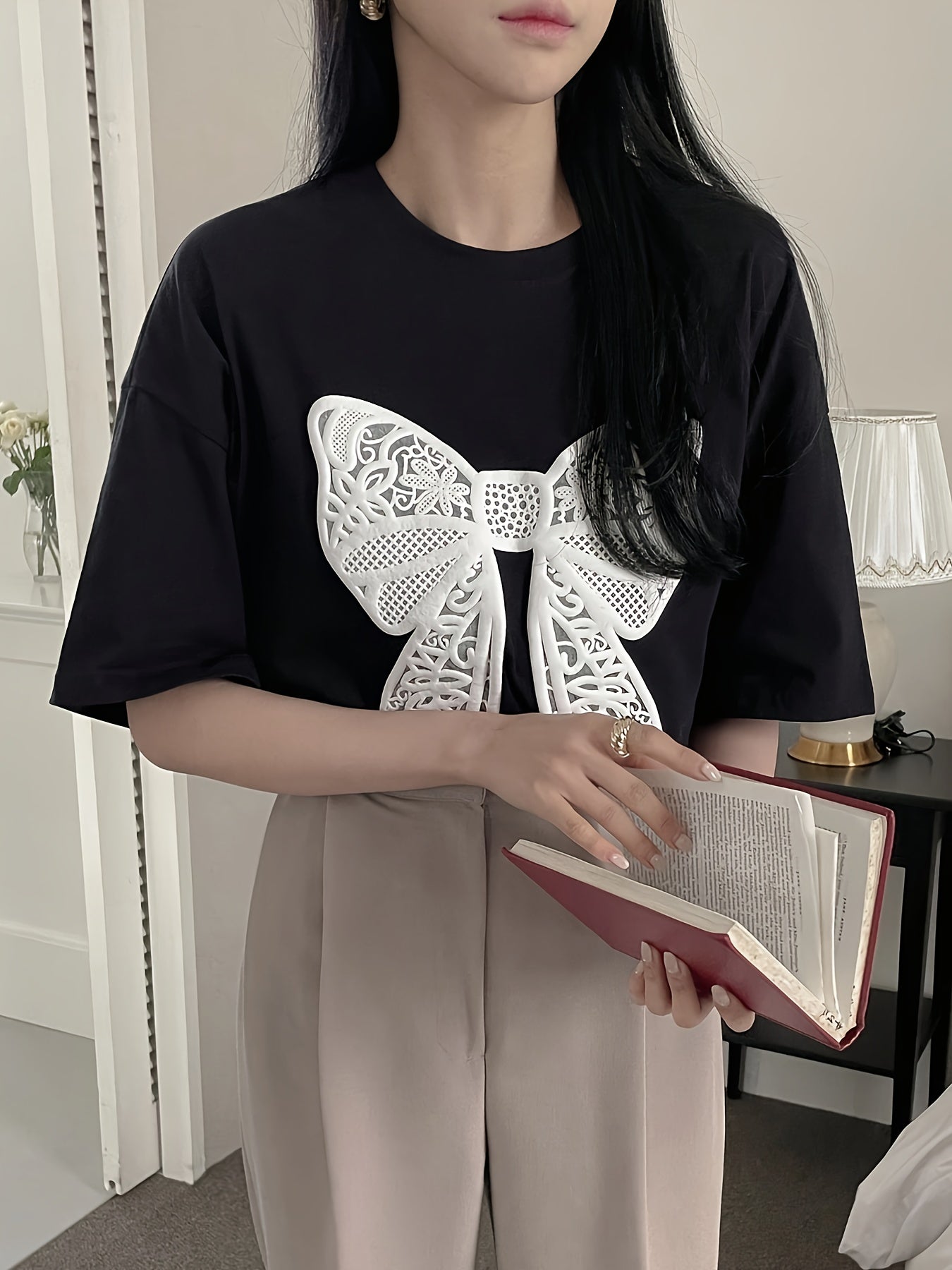 Women's casual crew neck t-shirt with lace bow pattern for spring and summer.