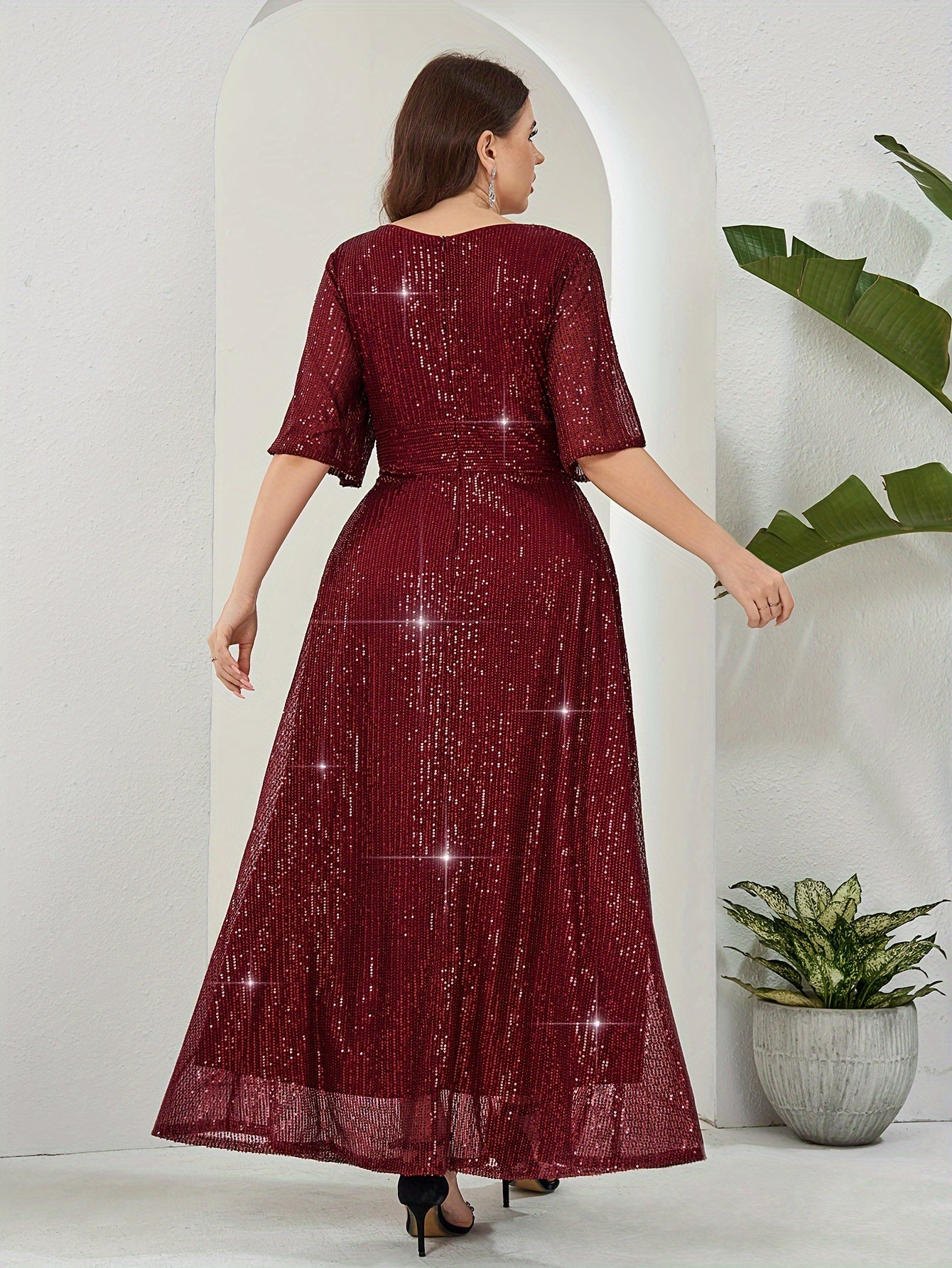 Elegant plus-size sequin maxi dress with v-neck and half sleeves. Made of non-sheer polyester with zip detail. Suitable for all seasons.