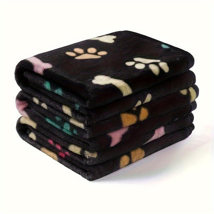 Stain-resistant fleece pet blanket with bone pattern, machine washable for dogs and cats, suitable for small to large breeds.