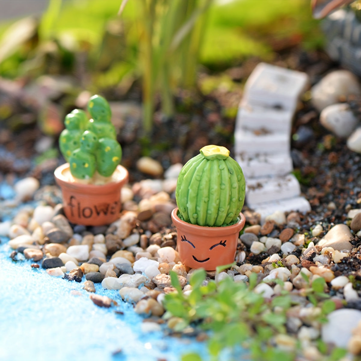 Miniature succulent and cactus fairy garden set with resin ornaments, ideal for small landscapes, desks, cakes, and gardens.