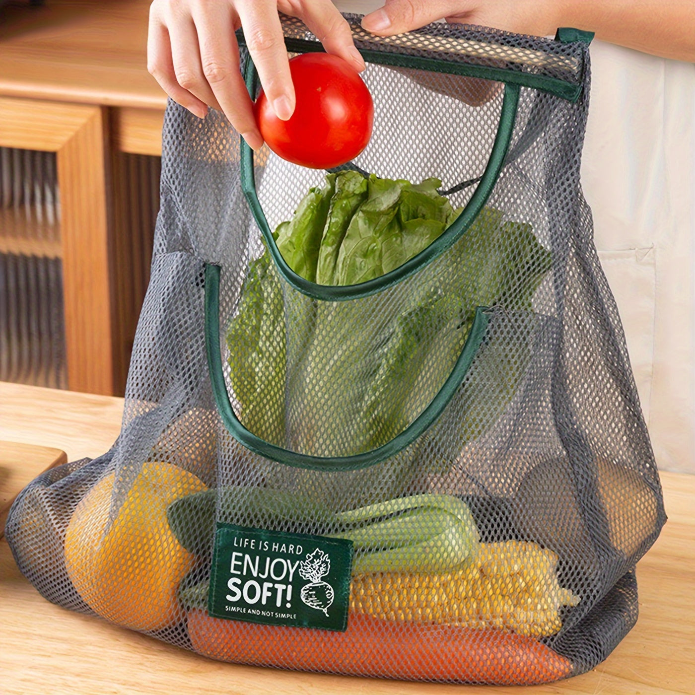 One piece of a mesh hanging bag ideal for storing a variety of items, including garlic, ginger, onion, fruits, and vegetables. This breathable and hangable bag is a versatile storage solution for your kitchen supplies.