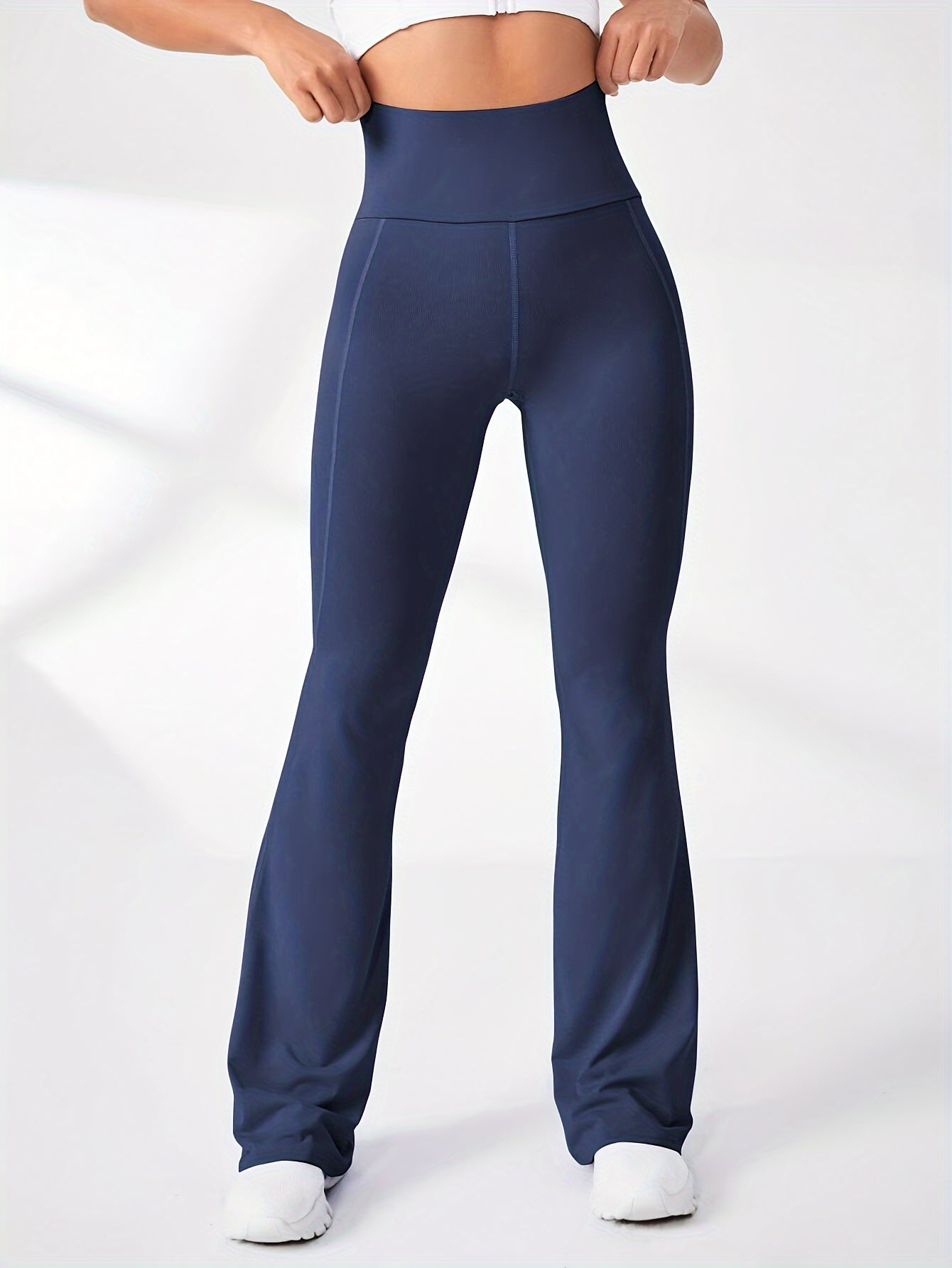 High-waisted solid color yoga pants with stretchy flared legs for women's activewear.