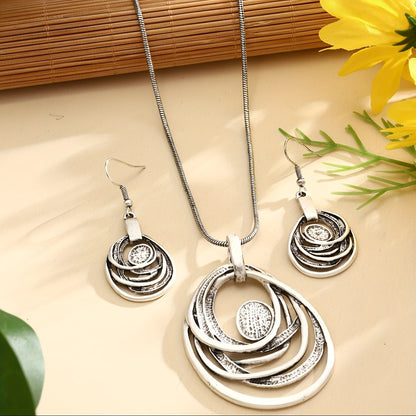 This set includes a pair of earrings and two necklaces made of zinc alloy in an ancient silvery color. The necklaces feature a multi-layer circular mosaic design with a retro bohemian style and a hollow center. This leisure jewelry set is perfect as a