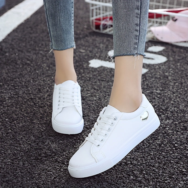 Stylish women's casual sneakers with heart-shaped design, lace-up style, and flat white soles - ideal for leisure wear.