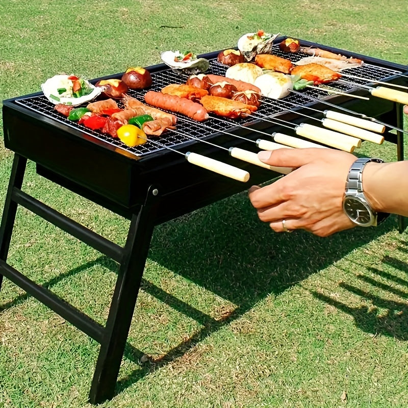 Portable folding charcoal BBQ grill with iron construction, perfect for picnics, camping, and backyard cookouts. Easy to transport and store with a black finish, ideal for grilling various