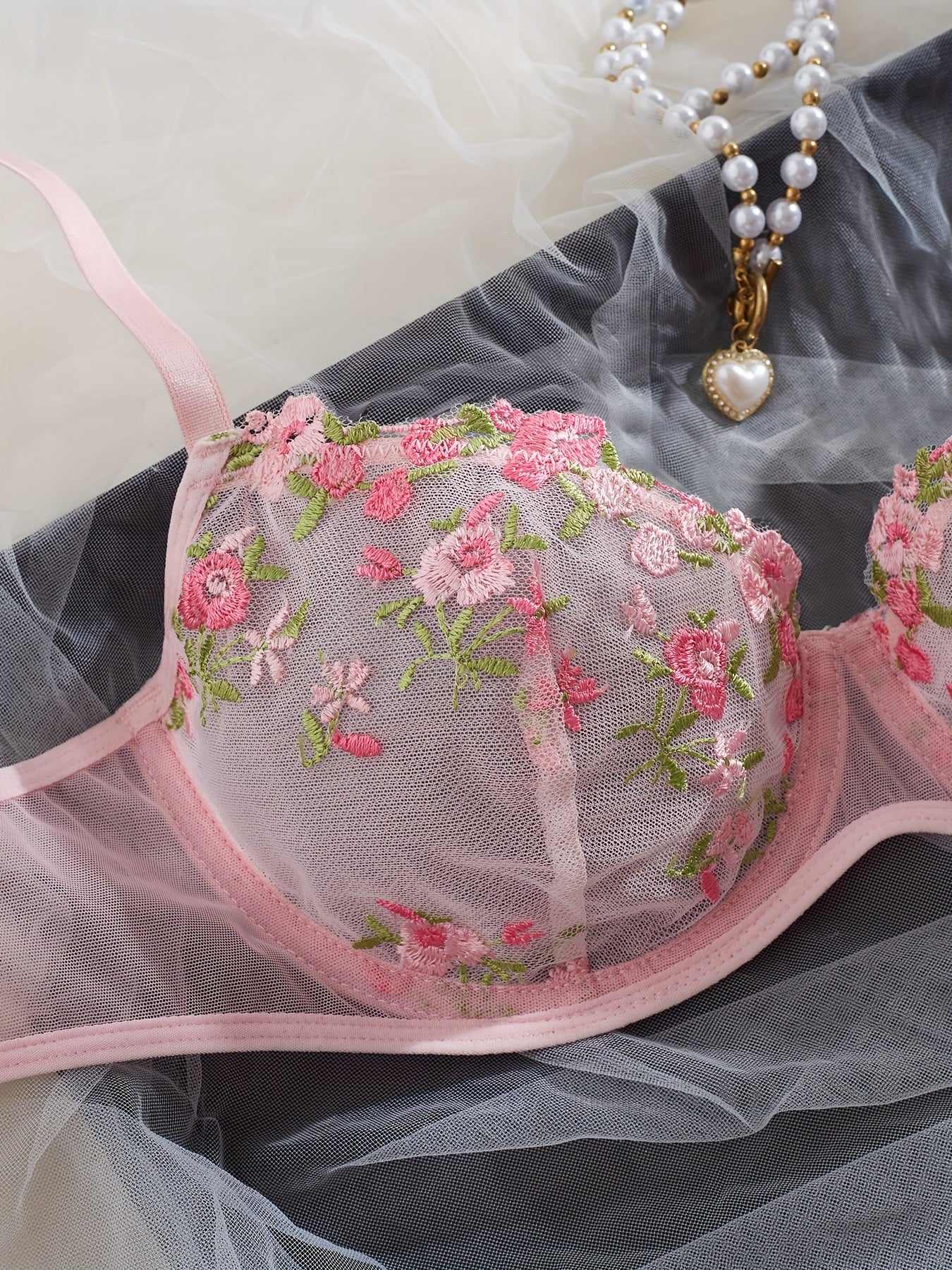 Chic French-inspired lingerie set in pink with floral embroidery and butterfly lace, featuring a sheer mesh bra and thong combo, medium support, hand wash only.