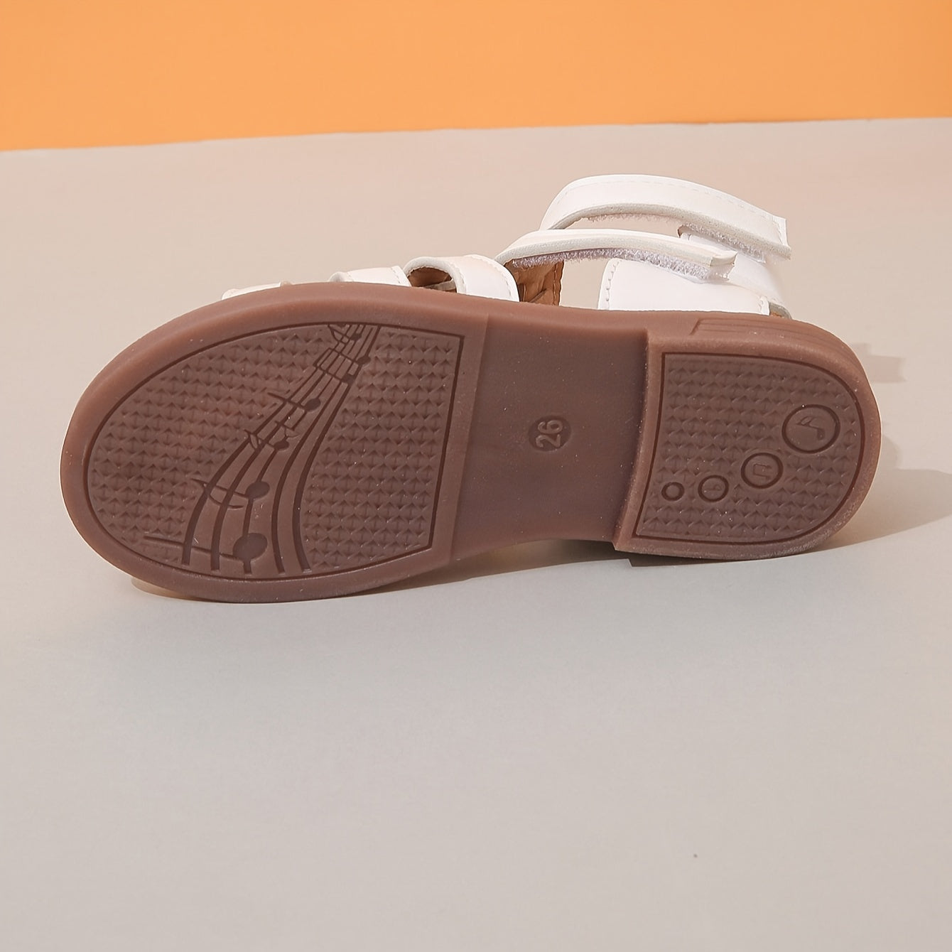 Ivory sandals for girls with brown sole, ideal for school and leisure activities.