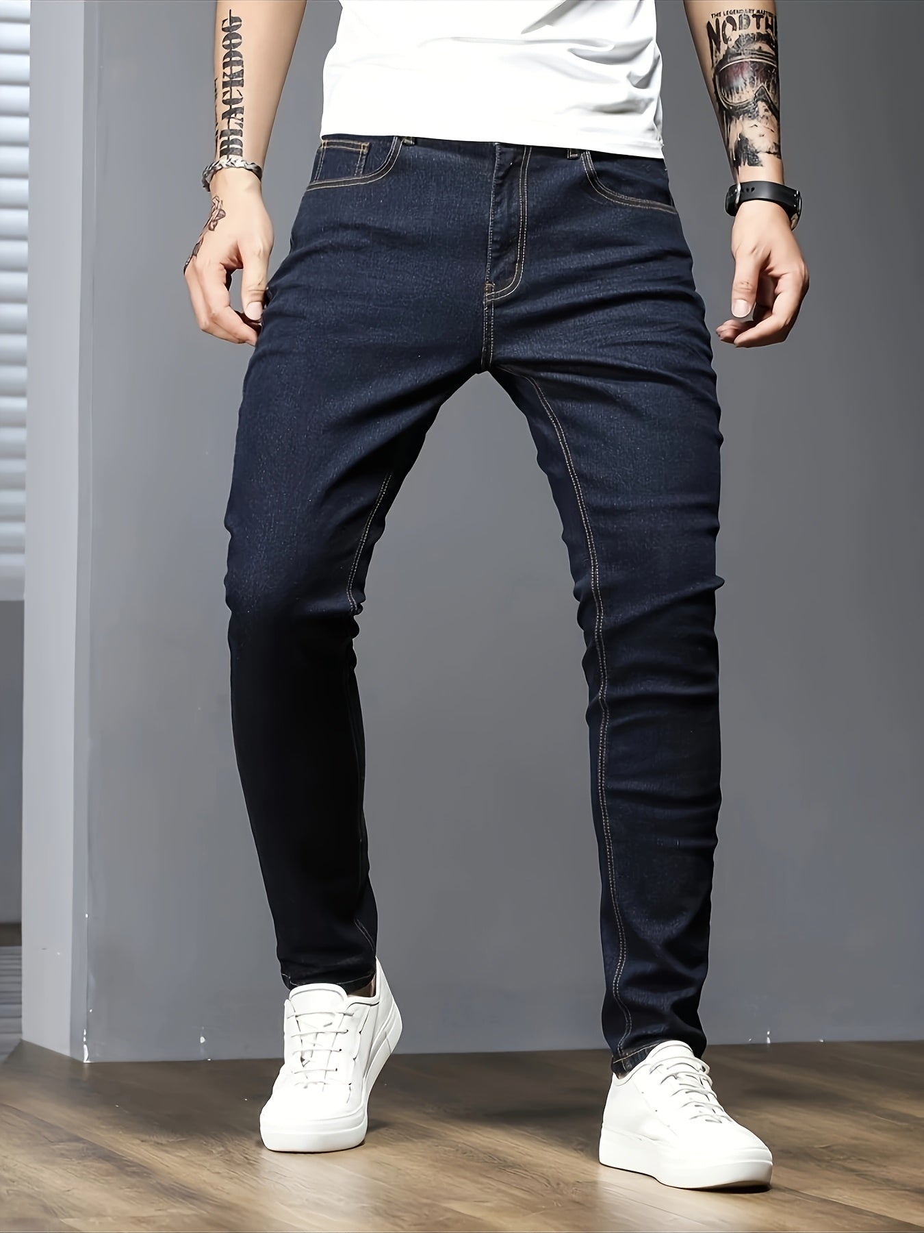 Men's slim fit jeans in solid color, made with stretch denim fabric and raw wash detail, suitable for all seasons.