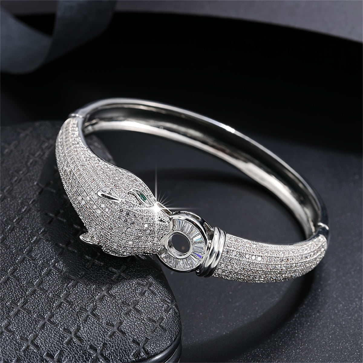 An elegant bracelet featuring a striking leopard head design, adorned with synthetic zirconia stones, making it a distinctive and opulent accessory for women to elevate their look at weddings and formal events.