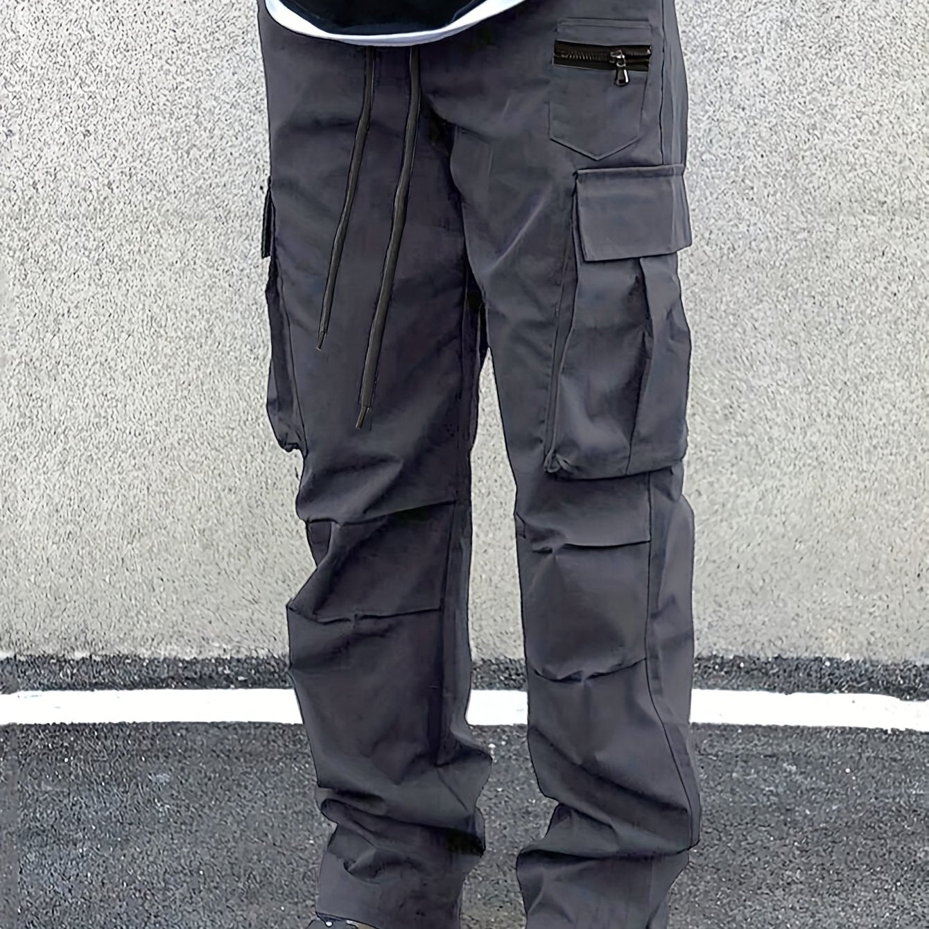 Plus size men's cargo pants in solid color with drawstring waist, multiple pockets, and woven material suitable for all seasons.