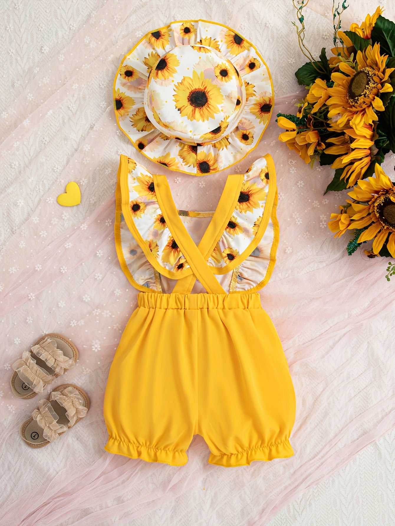 Cute sunflower and butterfly print baby girl jumpsuit with bow detail and matching hat. Made of polyester, machine washable. Perfect for summer and outdoor activities.