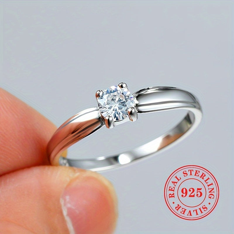 An elegant 925 sterling silver engagement ring featuring a dazzling zirconia stone held securely in four prongs. Perfect for brides, ideal for weddings, and a luxurious jewelry gift for any special occasion.