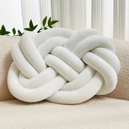 Knotted throw pillow for home decor, suitable for bed or sofa.