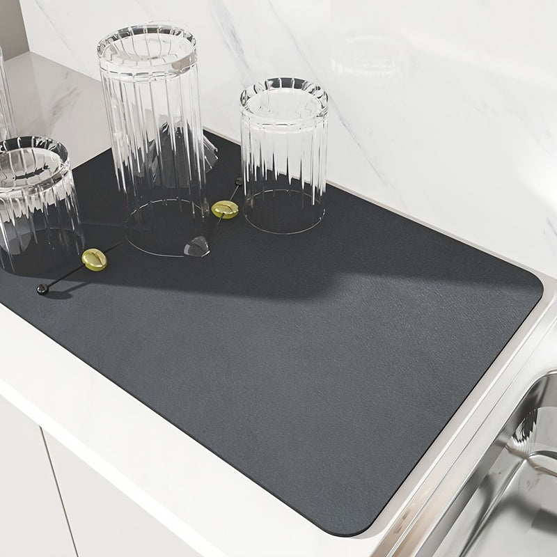 Sleek black dish drying mat absorbs moisture quickly and stays in place on kitchen countertops or tabletops. Ideal for dishes, bowls, and grinders in kitchen, coffee stations, or pet areas.