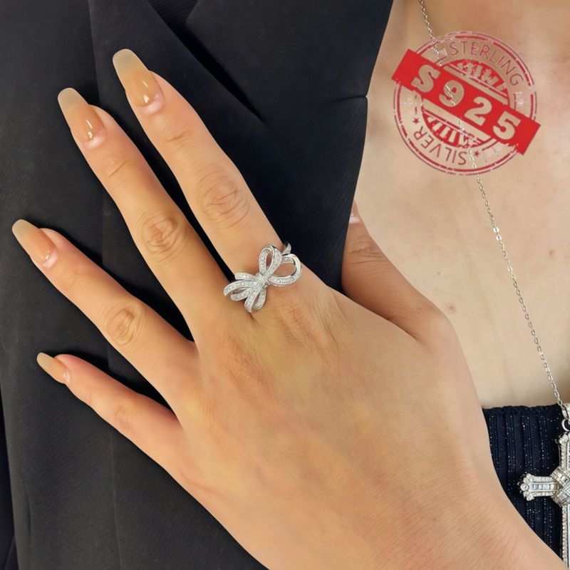 Chic 925 Sterling Silver Ribbon Bow Tie Ring featuring Natural Zirconia, perfect for July Birthdays. This Tribal & Cute style ring is 925 Silver Plated, Tarnish-Resistant, and adorned with Heart-Themed details. Ideal for Daily Wear or Wedding occasions