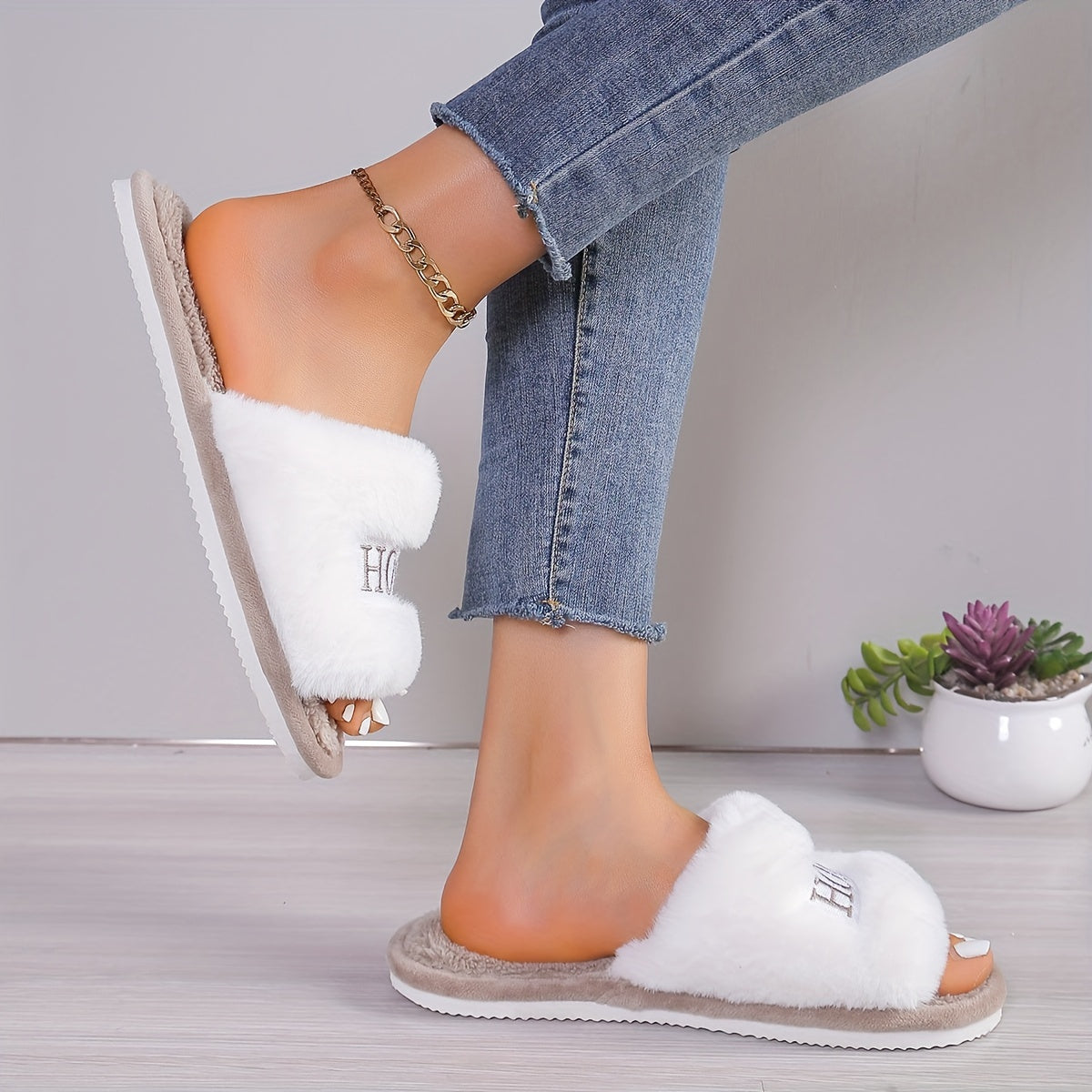 White plush slippers with "HOME" embroidery, cozy and comfortable for all seasons.