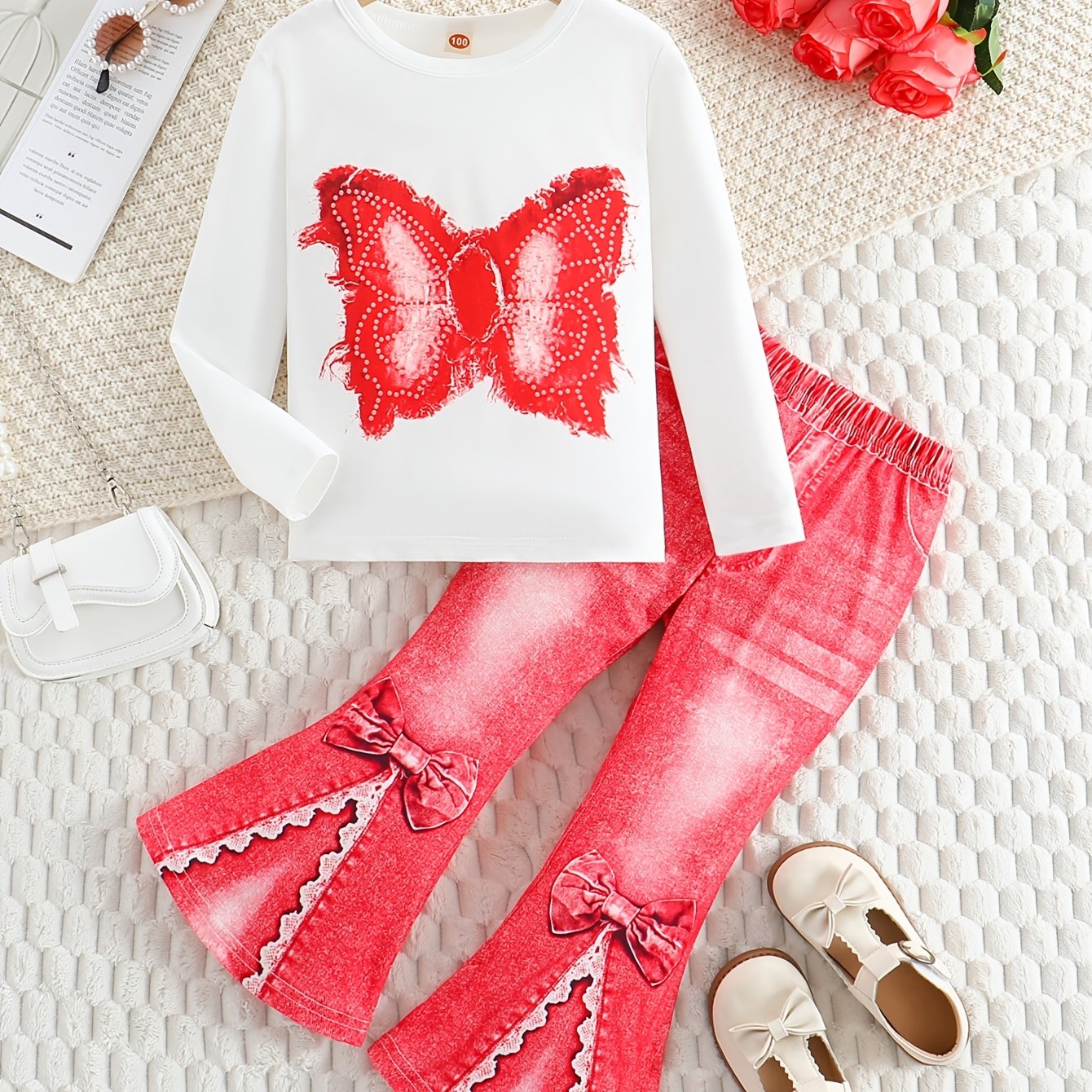 Girls' outfit set includes a long sleeve top with butterfly print and flared faux denim pants with a bow detail. Made of slight stretch knit fabric with an animal pattern, this regular fit