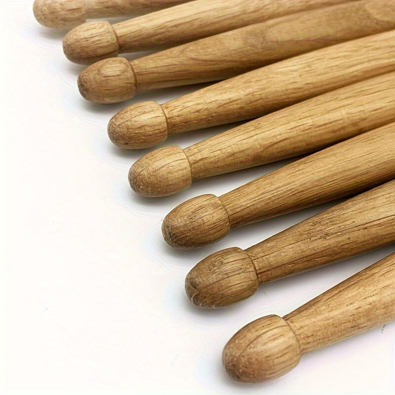 Set of 12 pairs of 5A/7A oak drumsticks for percussion instruments, jazz drumming, and electronic drums. Premium wood grain design for beginners and professional drummers. Labeled as