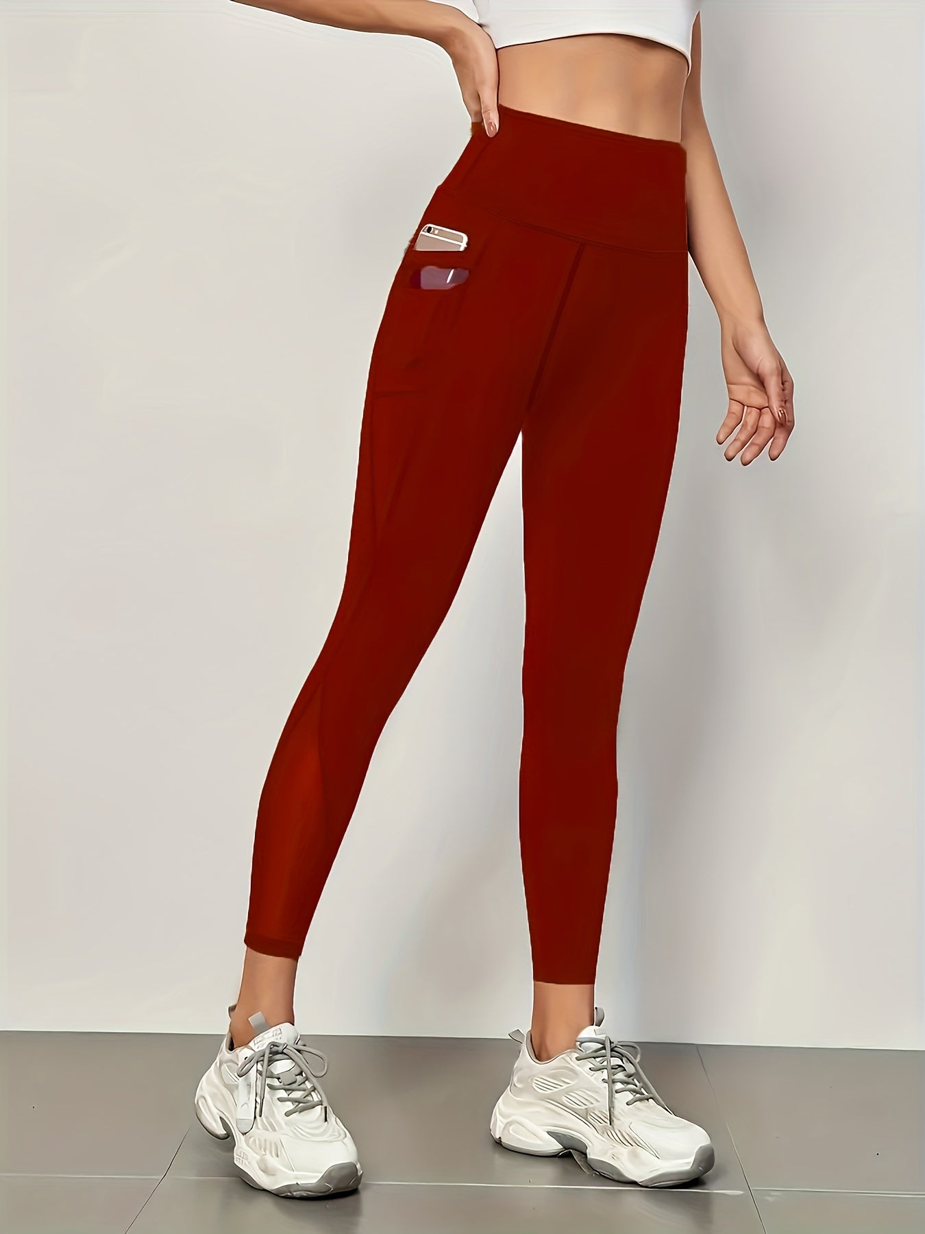 Mesh stitching yoga leggings for fitness and gym sports with high waist and side pockets.