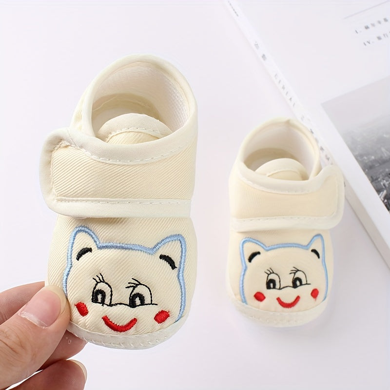 Cute baby walking shoes for boys and girls in light blue with cartoon faces, non-slip soles, and hook-and-loop closure. Ideal for first steps in any season.