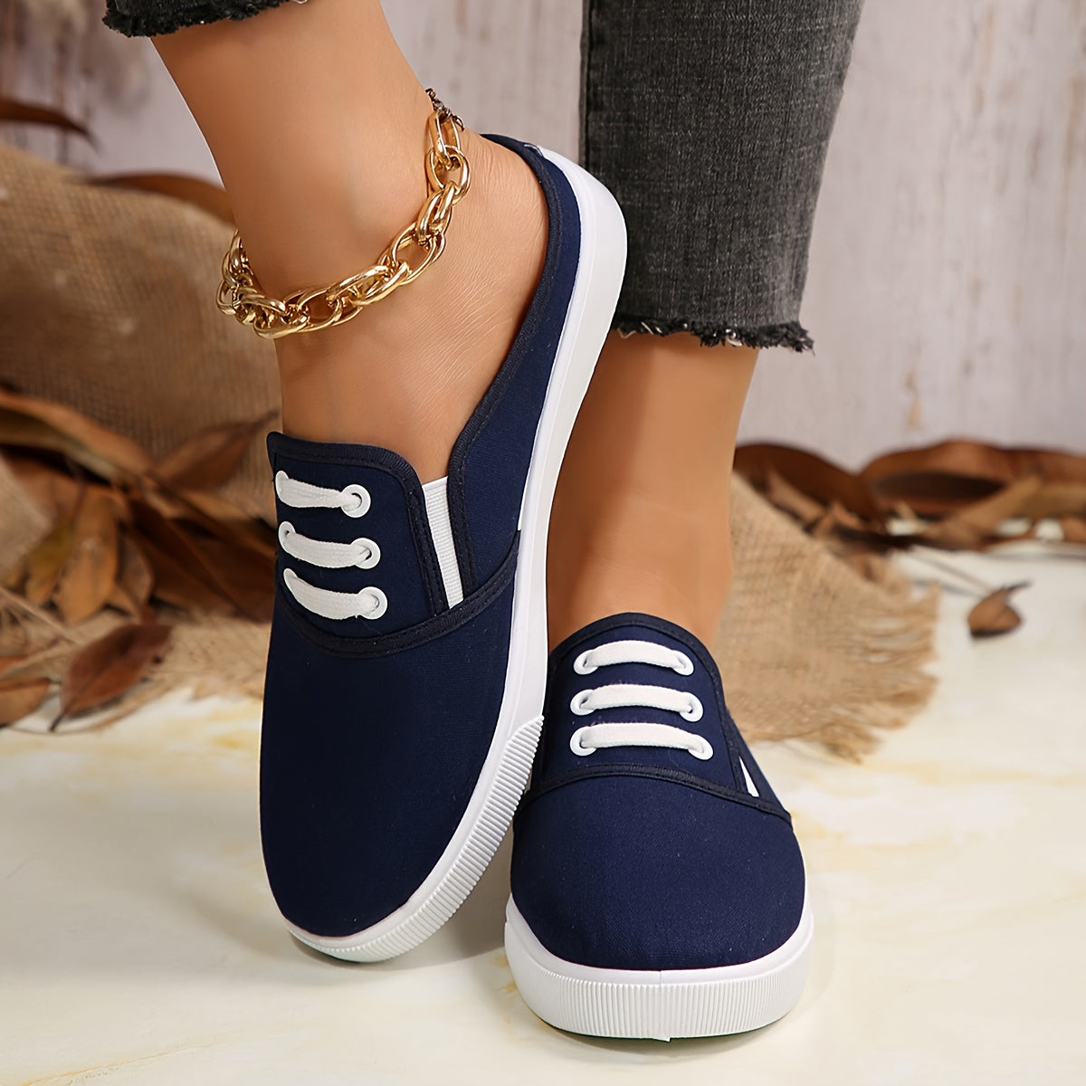 Lightweight white slip-on canvas sneakers for women with a soft sole and minimalist design.