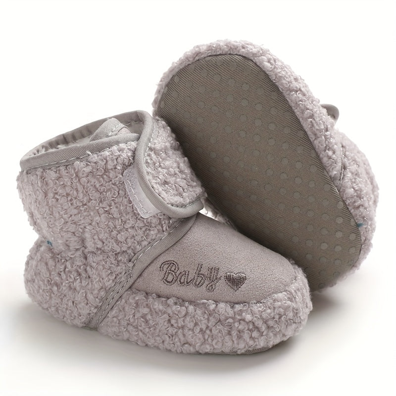 Cozy boots for baby boys and girls, featuring hook and loop fasteners for indoor and outdoor winter walks.