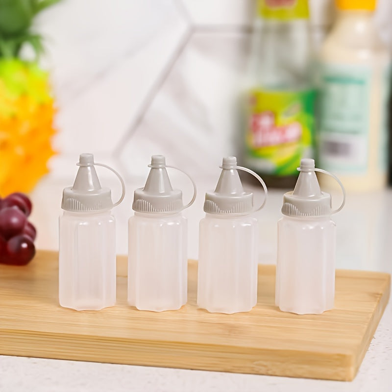 Set of 4 mini transparent seasoning bottles with gray lids, made of food-grade plastic for sauces and dressings. Portable and reusable squeeze containers for BBQs and kitchen use, hand-wash only.