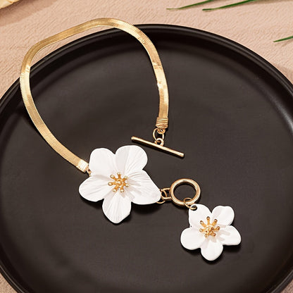 Stylish gold-tone anklet with white flower charms, perfect for vacations and everyday wear.