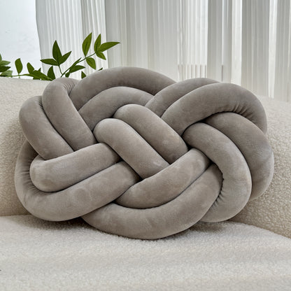 Knotted throw pillow for home decor, suitable for bed or sofa.