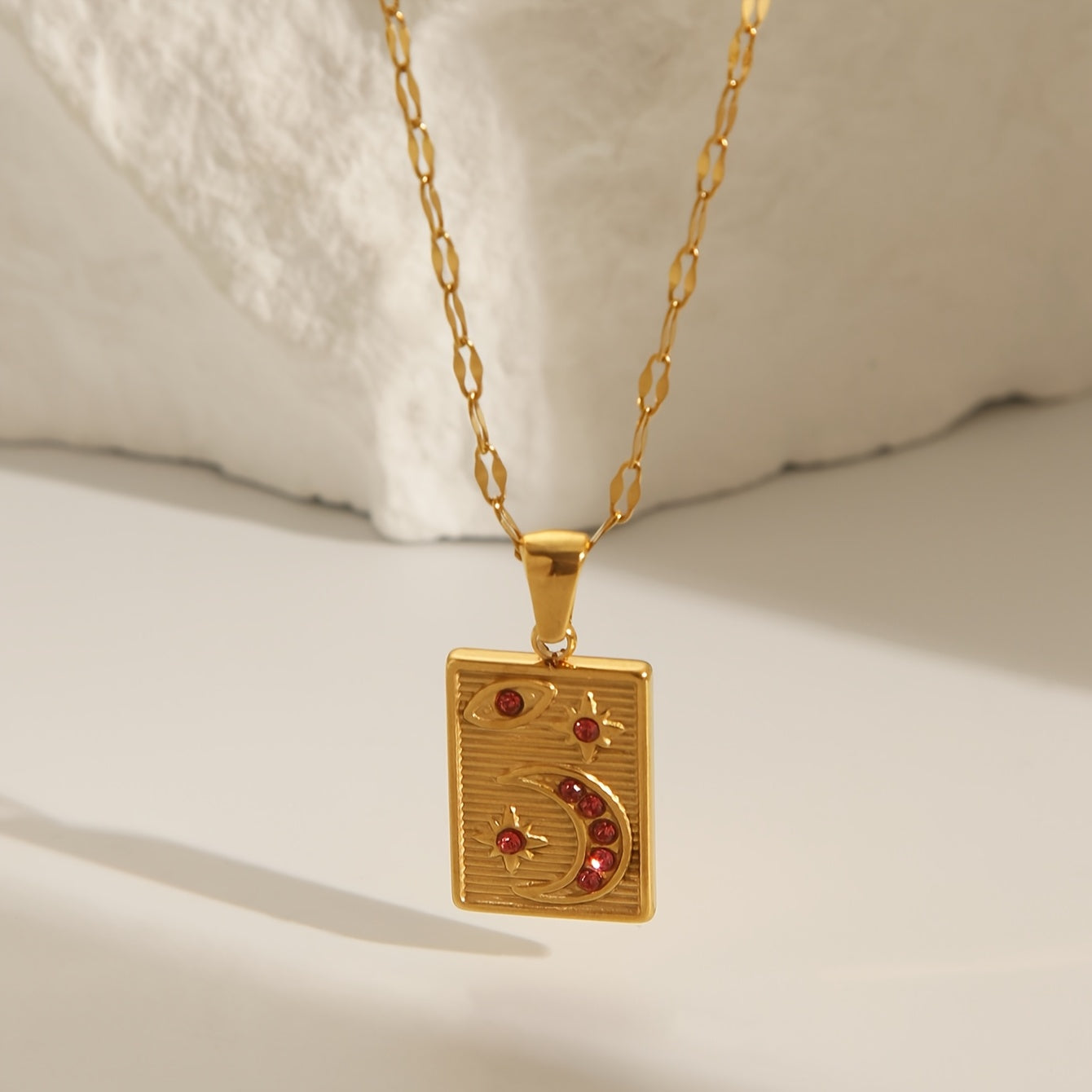 18K Golden Plated Stainless Steel Pendant Necklace featuring a Minimalistic Geometric Rectangle & Crescent Moon Design adorned with Red Synthetic Zirconia Stones, a Stylish and Versatile Piece of Fashion Jewelry perfect for Women to Wear on Both Daily