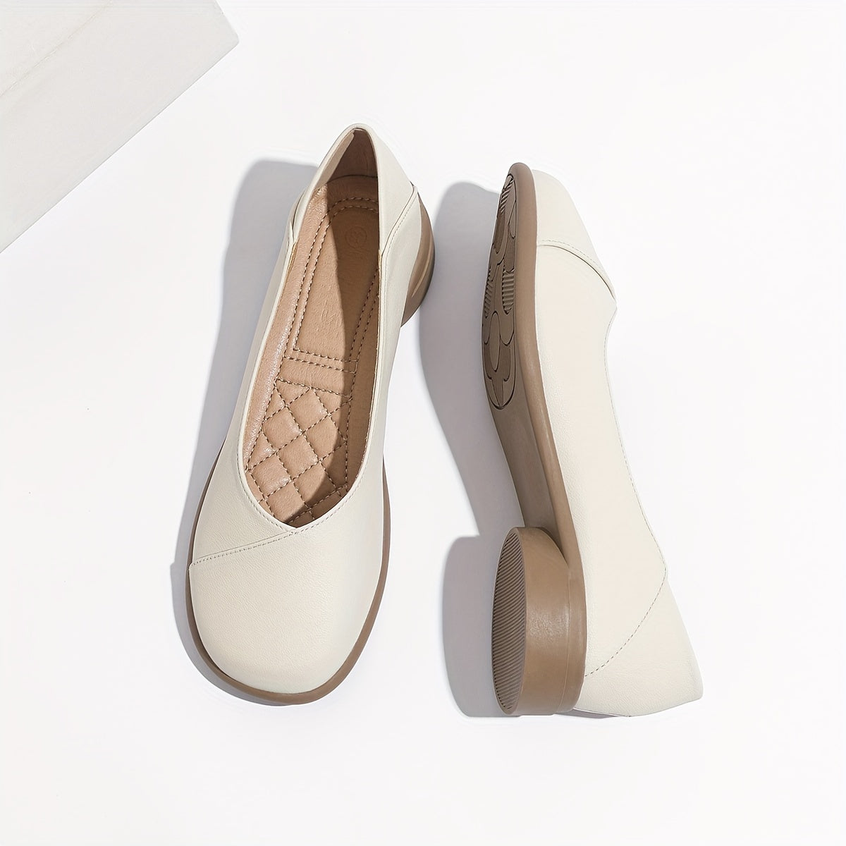 Stylish white low heel flats with all-day comfort for work.