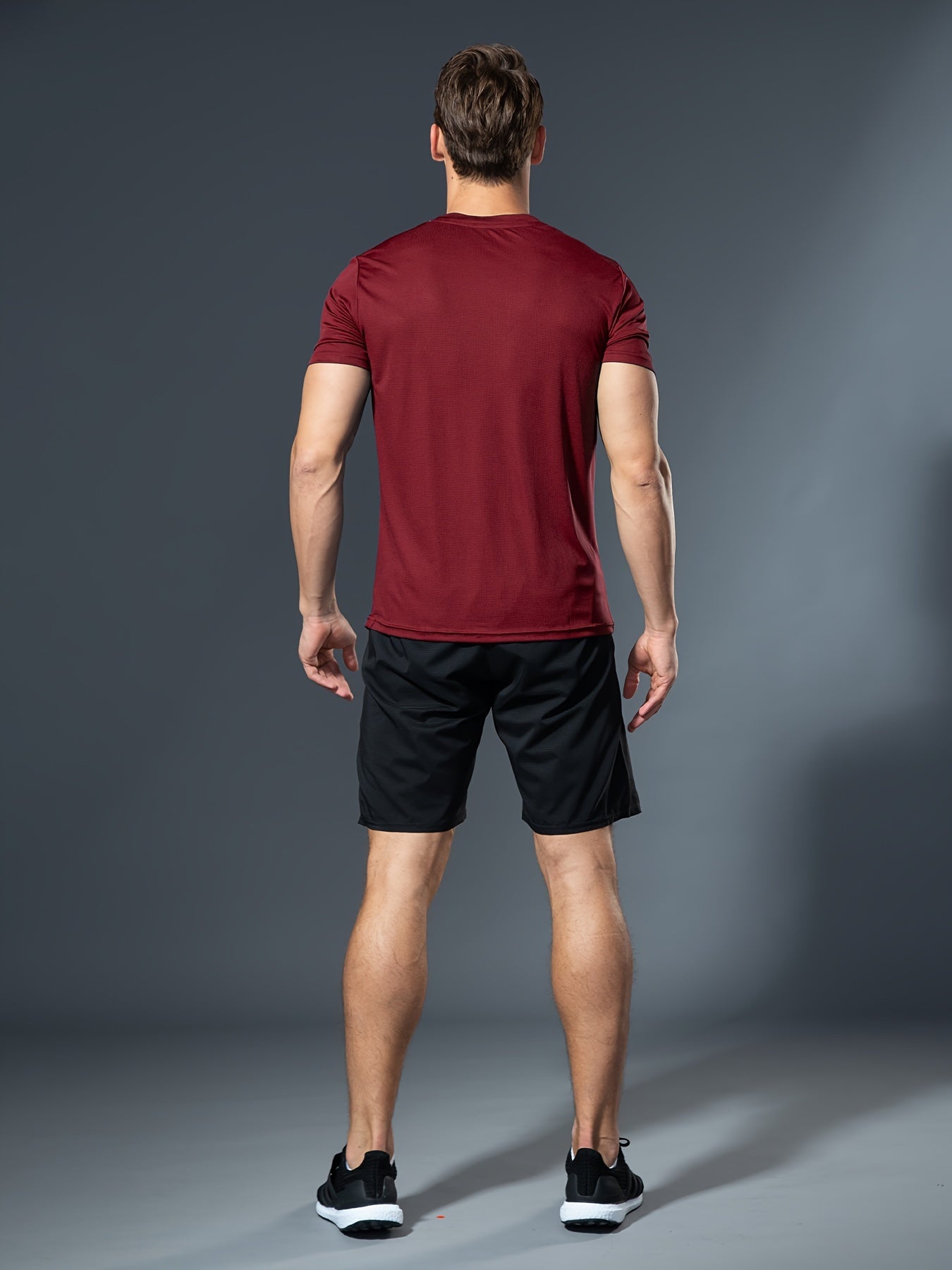 Summer men's fitness set includes white t-shirt and black shorts made of lightweight, quick-dry, breathable polyester for running, basketball training, and athletic wear.