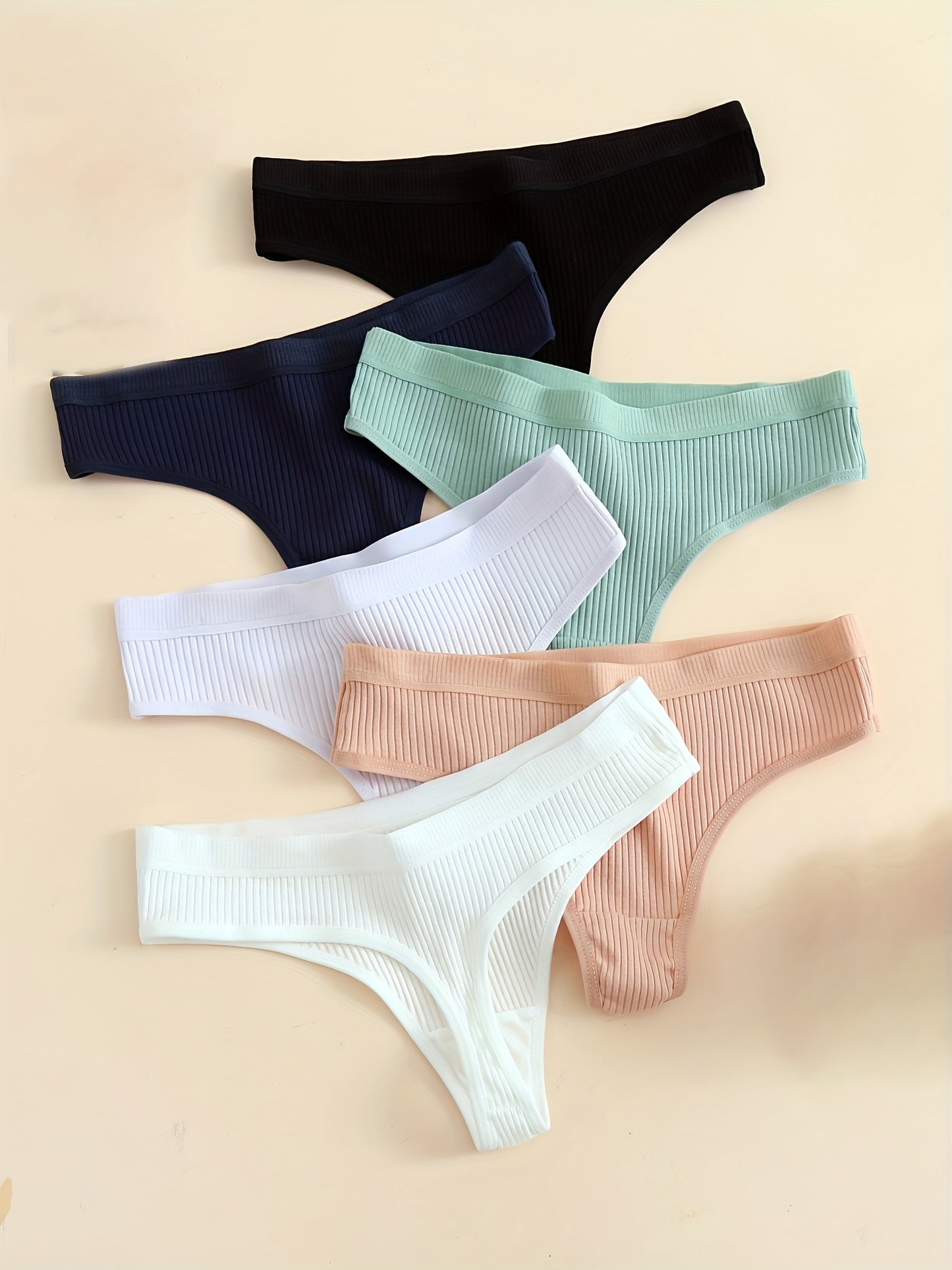 6-Pack of comfortable seamless cotton thongs for women, v-string style with low waist, solid color, simple design, and non-see-through fabric.