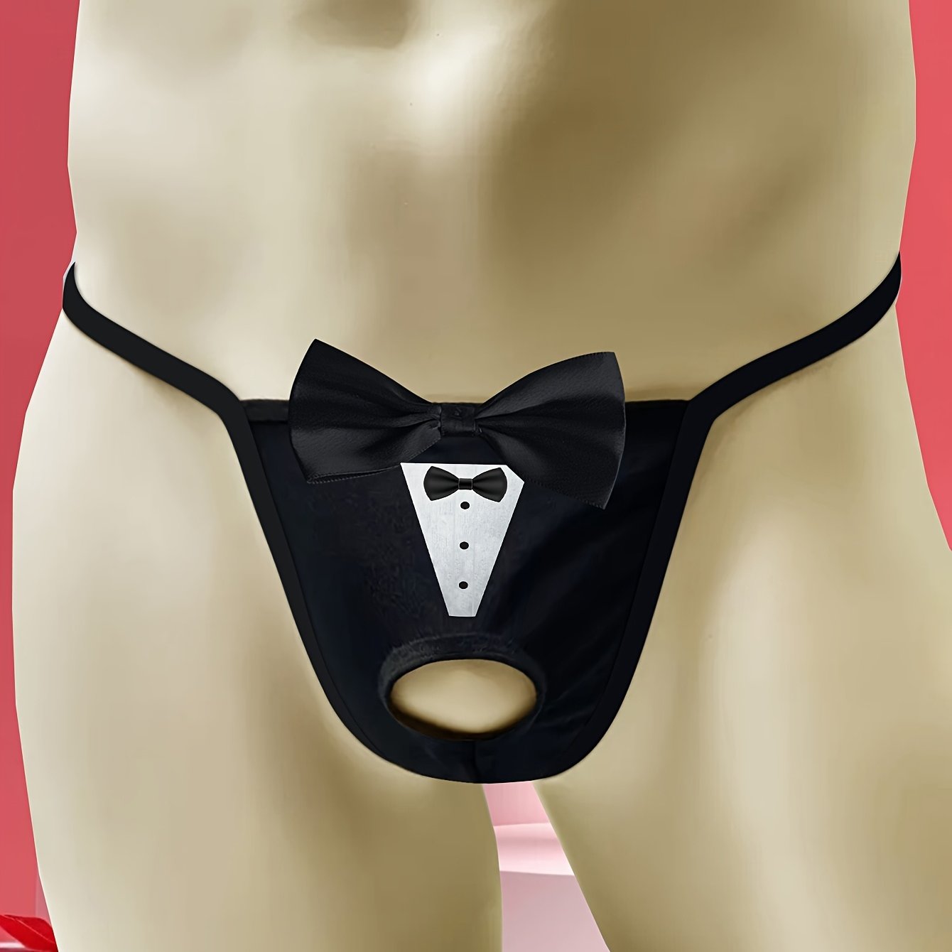 Sexy low-rise jockstrap for men with playful tie print and front bow detail. Breathable and stretchy black fabric with open crotch design for comfort and style.