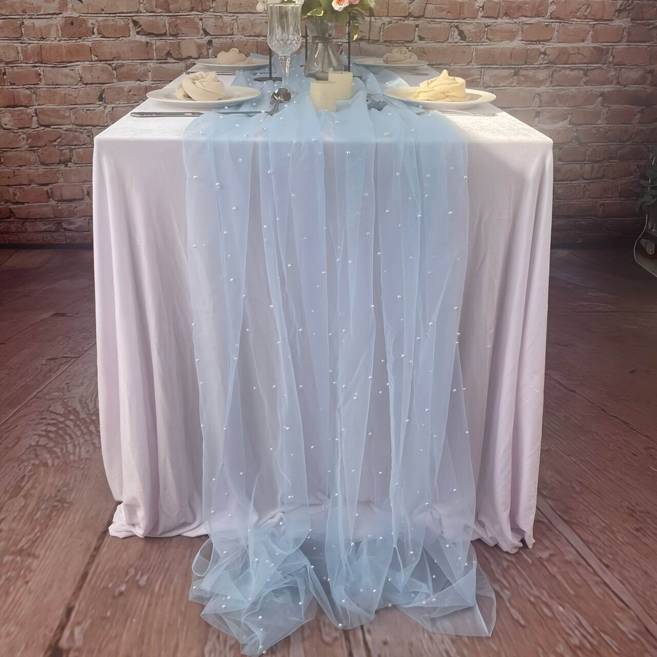 Enhance the ambiance of your special events with our Romantic Pearl Lace Table Runner. Perfect for weddings, bridal showers, and more, this elegant decoration is crafted from embroidered sheer chiffon tulle that is wrinkle-free for a luxurious look.