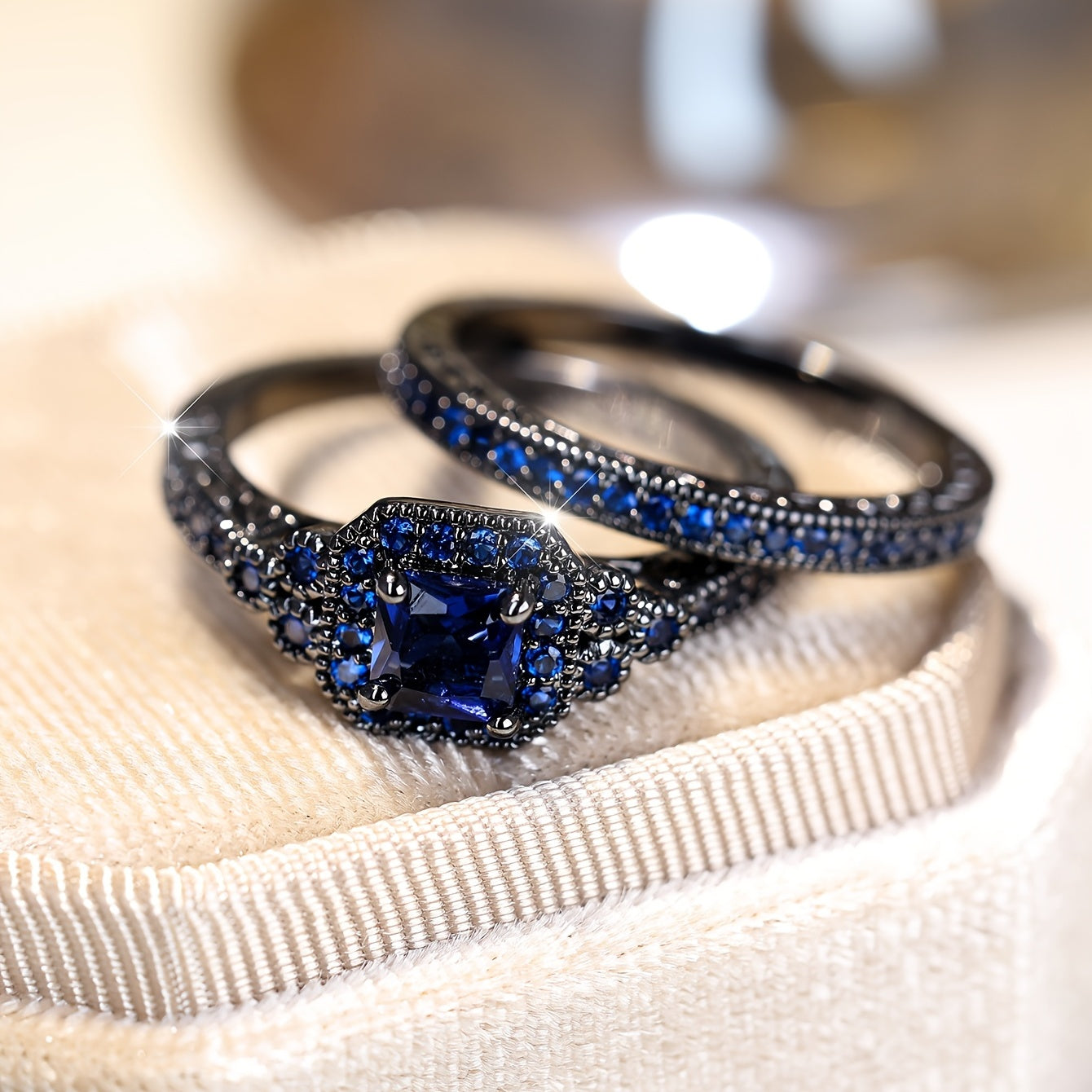 Set of 2 elegant promise rings featuring a halo ring with a dark blue zirconia stone and an eternity ring, perfect for engagement or wedding jewelry. Ideal for brides to enhance their evening party attire.