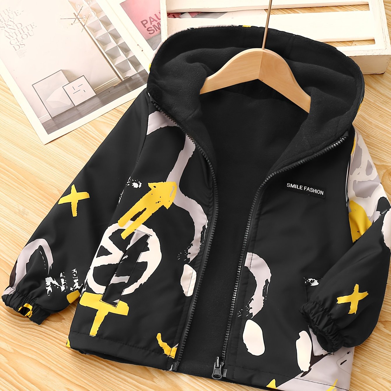 Kids' reversible hooded jacket featuring a cute bear pattern, fleece-lined for warmth in fall/winter. Made of polyester with pockets.