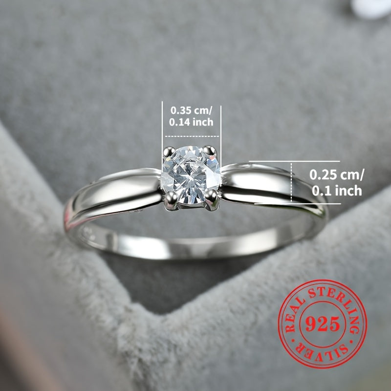 An elegant 925 sterling silver engagement ring featuring a dazzling zirconia stone held securely in four prongs. Perfect for brides, ideal for weddings, and a luxurious jewelry gift for any special occasion.