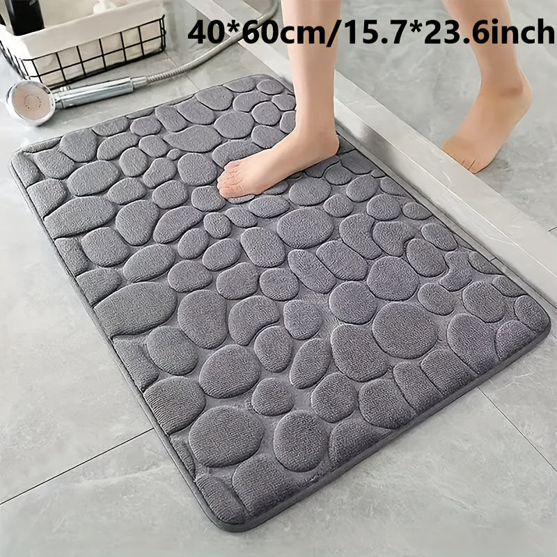 Soft and luxurious memory foam bath mat with a non-slip pebble design. This water-absorbent bathroom rug is machine washable and made of flat woven polyester with PVC backing. Featuring a low pile and solid pattern, it has non-slip capabilities for added