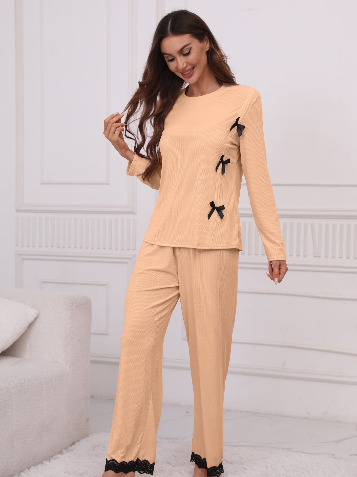 Women's lounge set with lace trim, crew neck top, and elastic waistband pants.