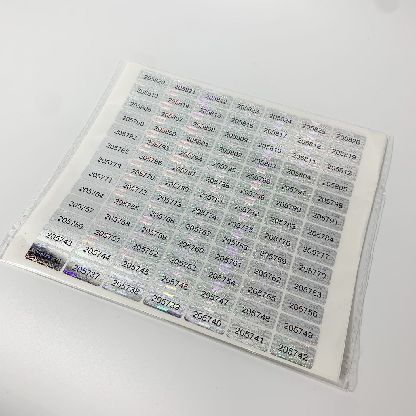 273/588 Tamper Evident Hologram Seals with Unique Serial Numbers, Genuine Labels, Adhesive PET, Rectangle, Gloss Finish, English Text, Single Use, 20x10mm