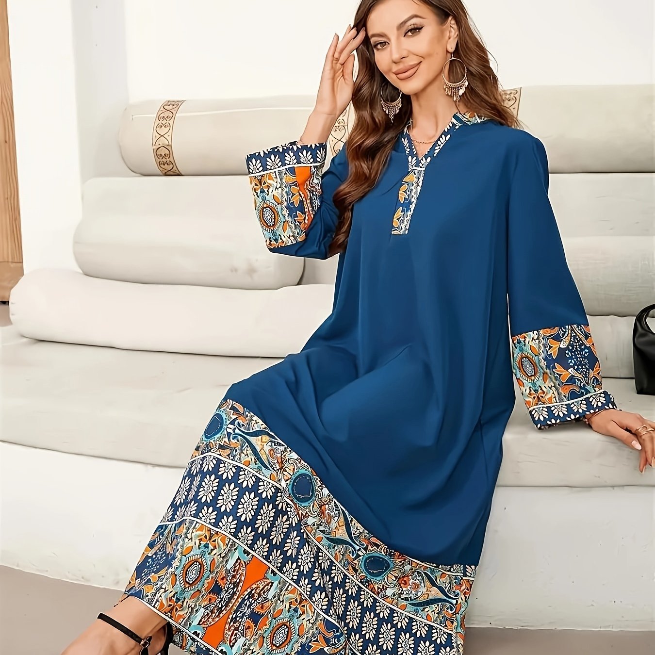 Elegant two-tone Muslim Abaya dress with paisley and floral design, blue long sleeves, polyester fabric, asymmetrical hem, and includes hijab. Ideal for all seasons.