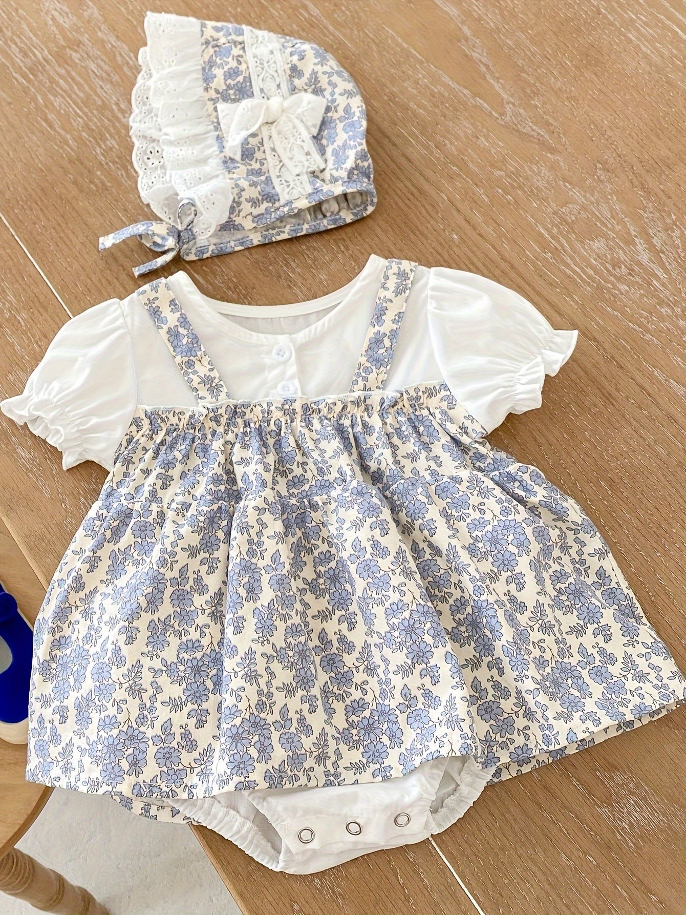 Baby's floral pattern romper dress with puff sleeves and matching hat, perfect for outdoor wear for toddler and infant girls.