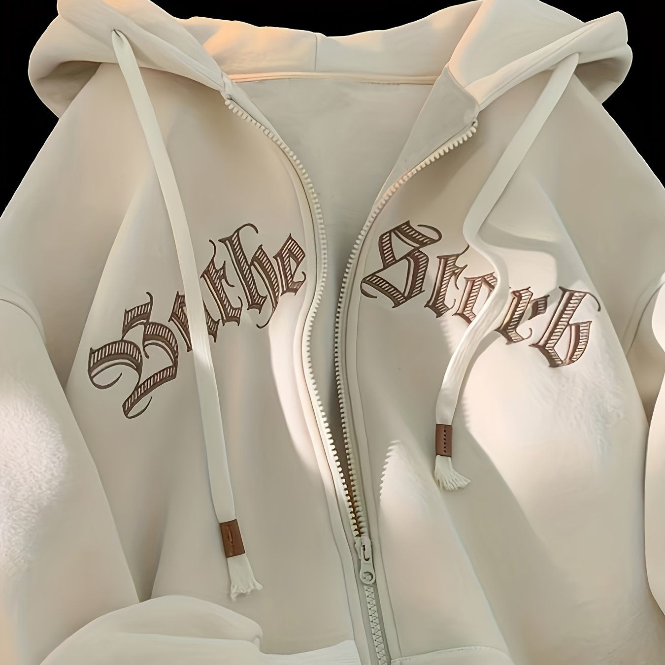 Women's chic zip-up hoodie jacket featuring "THE STRK" embroidery on long sleeves, made of polyester, ideal for spring and fall.