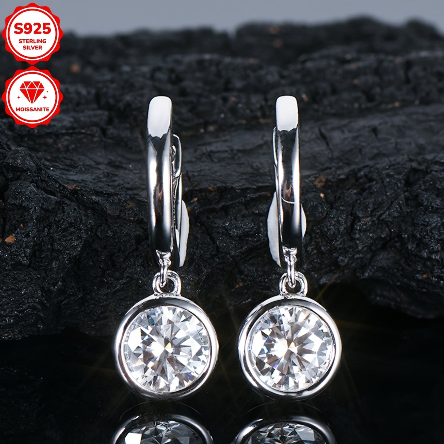 Pair of elegant Moissanite earrings with a silvery gram weight of 2.52g. Featuring two 6.5mm Moissanite stones totaling 1.0 carat each, set in 925 Sterling Silver. These round Moissanite earrings are perfect for adding a touch of glamour to any outfit