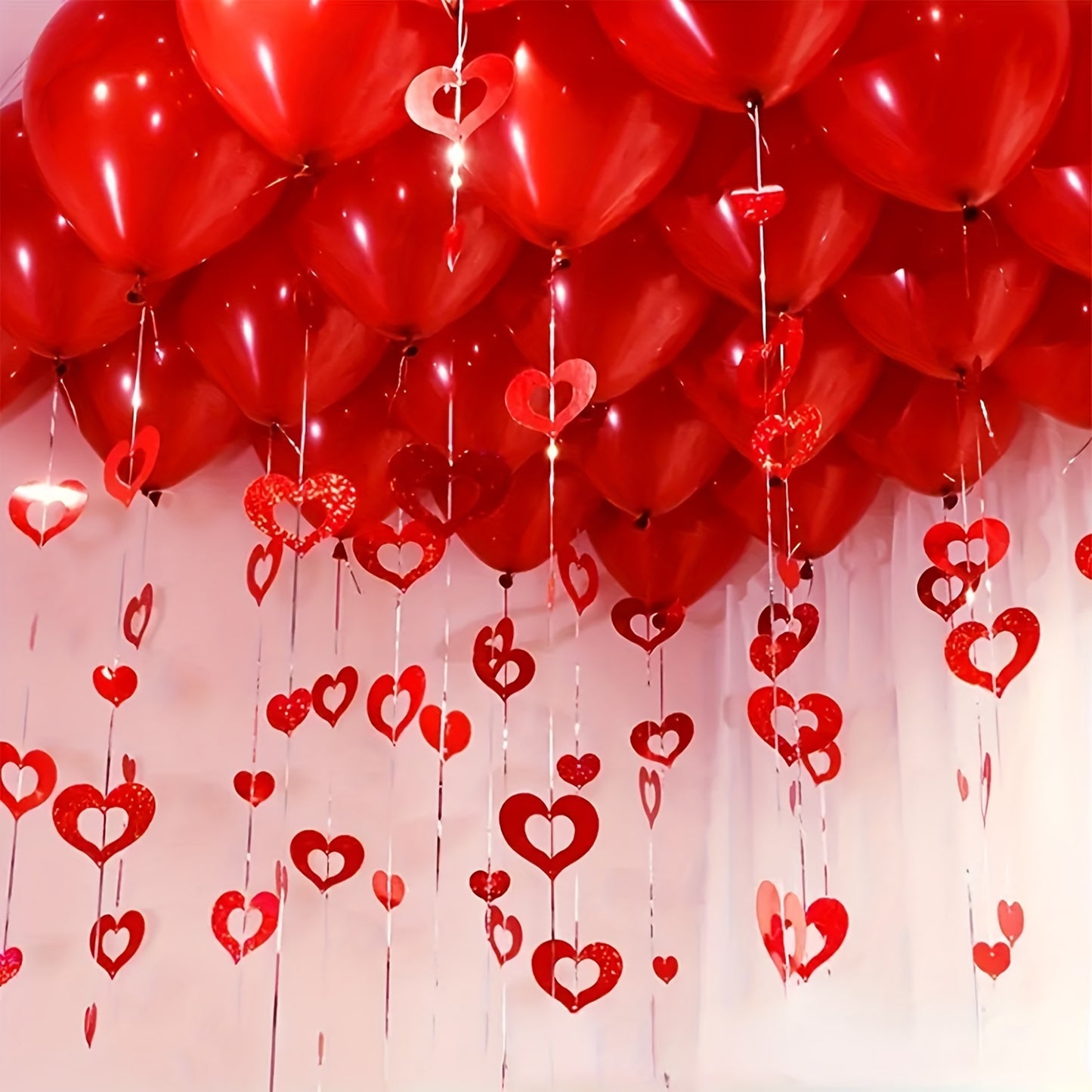 200 Valentine's Day hanging heart decorations. Ideal for weddings, birthdays, parties, and romantic room decor. Made of plastic red hearts and silk strings. Non-electric and featherless.