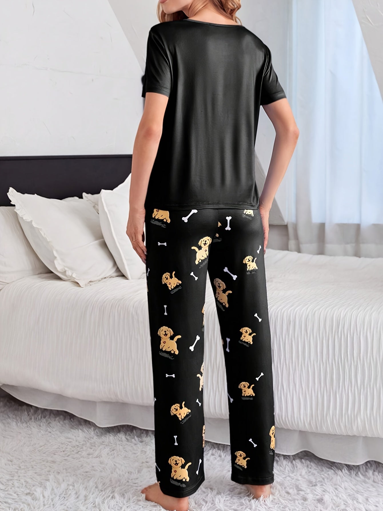 Women's sleepwear set with cute puppy print, short sleeve top, and elastic pants.