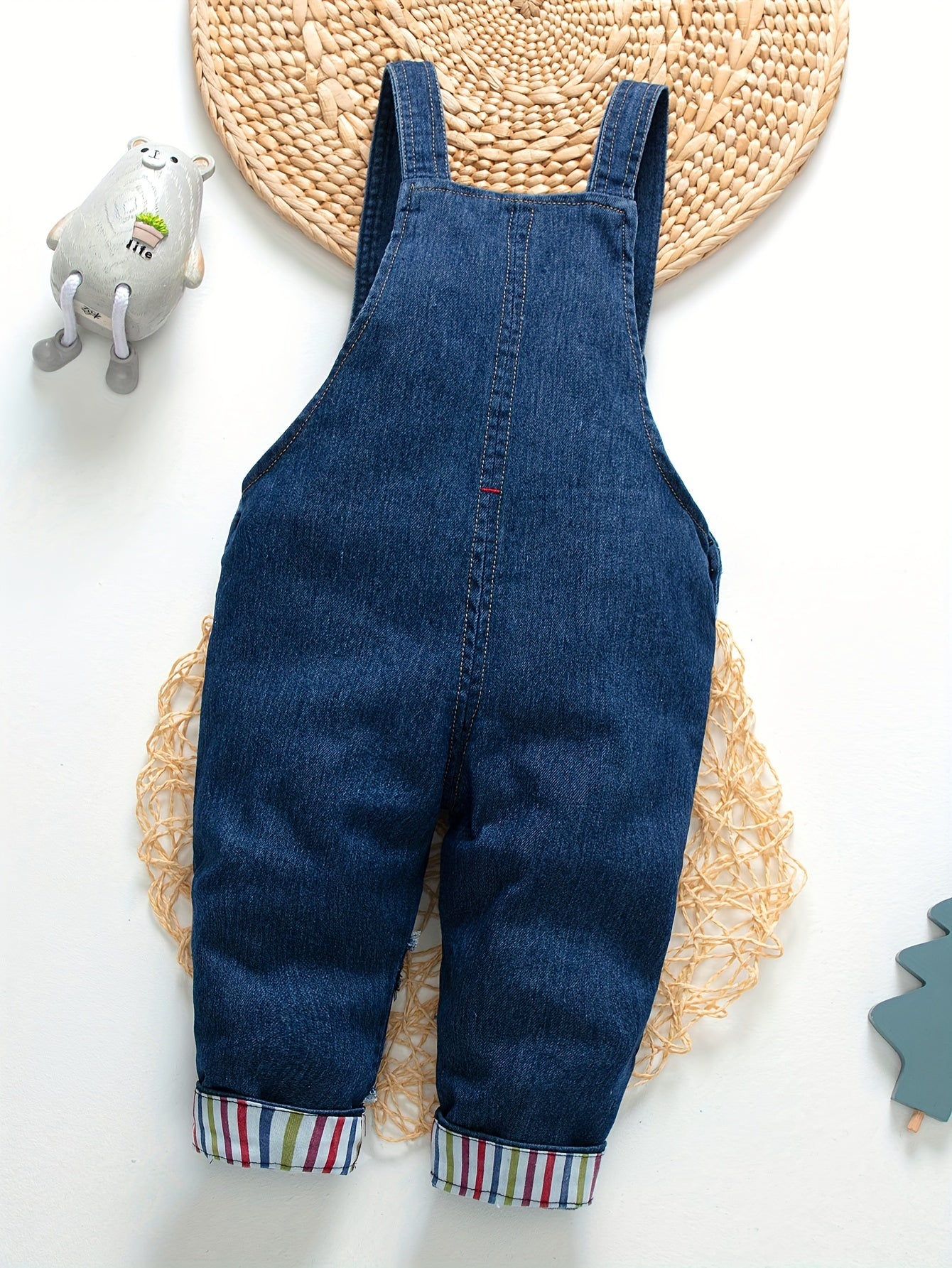 Children's denim overalls with embroidered animal designs, made of a cotton blend with slight stretch, suitable for outdoor wear in the spring and fall.