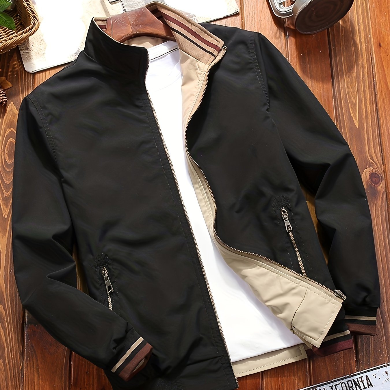 Men's olive green casual jacket with dual-sided design, pockets, stand collar, and striped cuffs. Ideal for spring/fall and travel. Zipper closure.